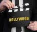 businessman-holds-up-slapperboard-with-text-bollywood_132358-4934